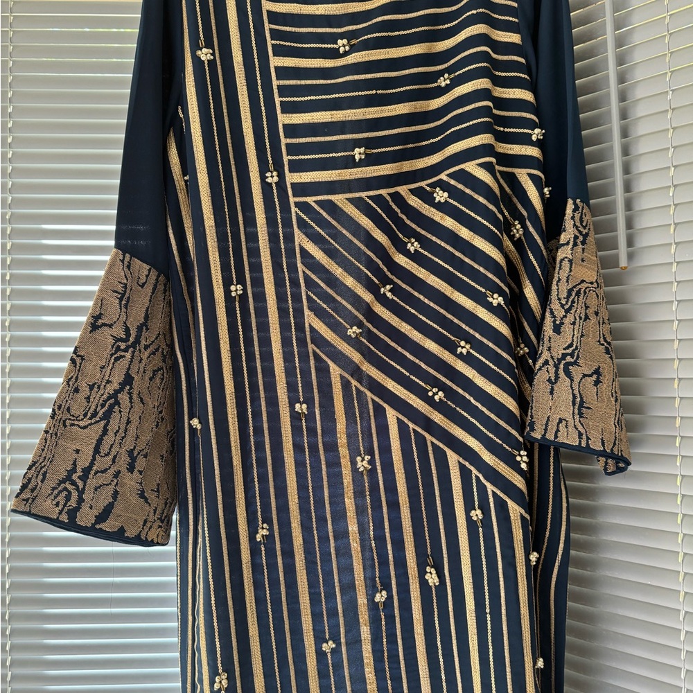 Beautiful zinc colored crepe shirt with sequins and pearl sprinkle .